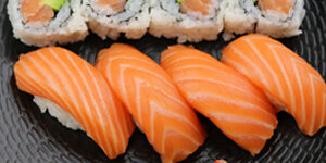 Four pieces of salmon sushi and four salmon & avocado rolls